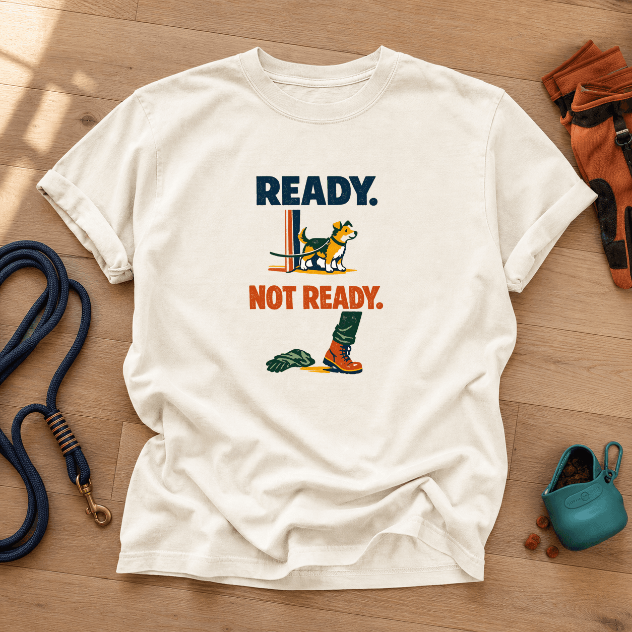 Ivory Comfort Colors T-shirt printed with Ready above an eager dog at the door and Not Ready beside one boot and a dropped glove.